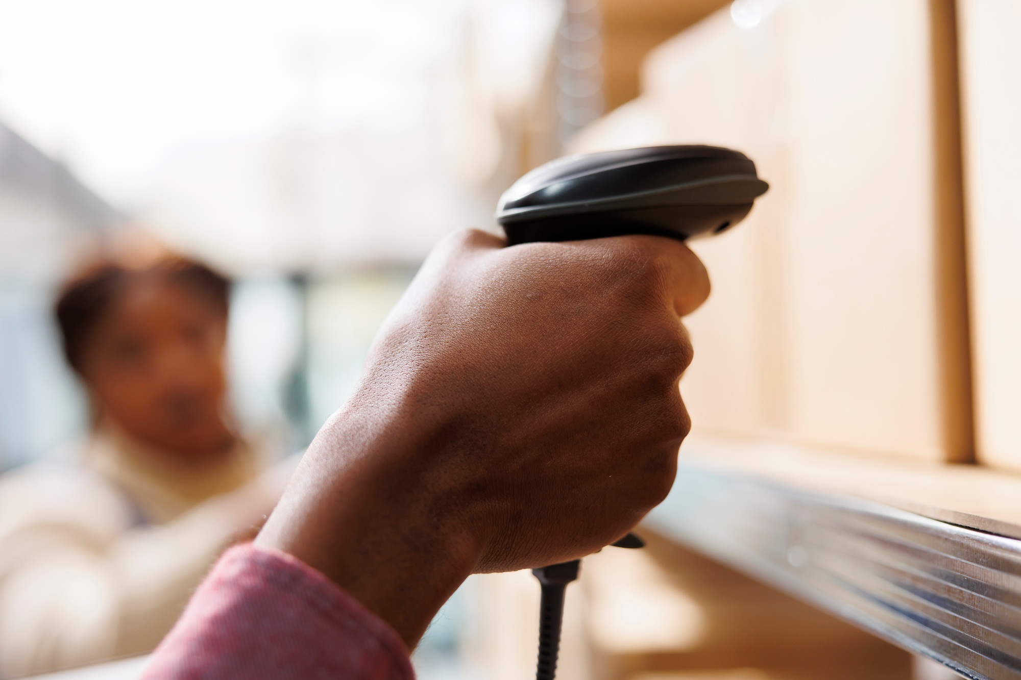 African american warehouse worker hand holding barcode scanner