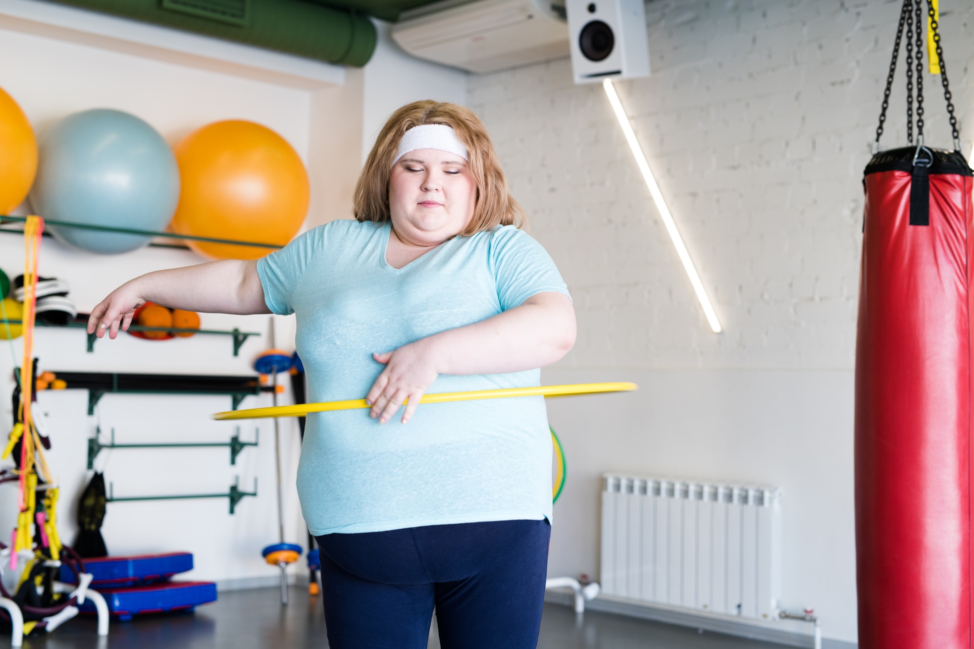 Obese Woman Working Out with Hula Hoop